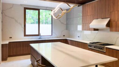 white quartz kitchen countertops installed in a modern kitchen with white cabinets and waterfall island