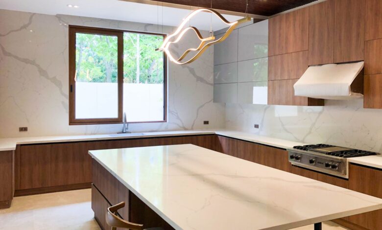 white quartz kitchen countertops installed in a modern kitchen with white cabinets and waterfall island