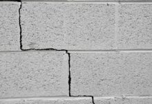 signs of foundation problems in house including wall cracks and uneven floors