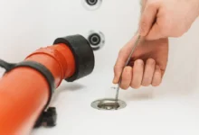 Pouring boiling water into a clogged kitchen sink drain