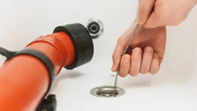 Pouring boiling water into a clogged kitchen sink drain
