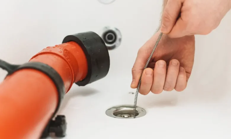 Pouring boiling water into a clogged kitchen sink drain