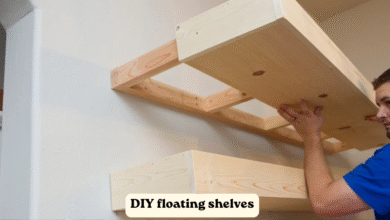 DIY floating shelves installed on a living room wall with wood finish