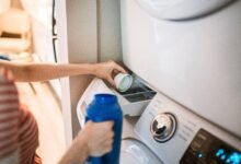 how to clean a washing machine — front-load washer with open door showing clean drum
